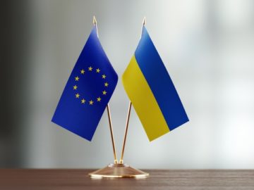 Ukraine European Union flags on table EU to Compromise on Russia Sanctions for Grain Corridor