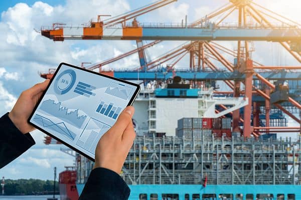 port loading crane with containers and tablet computer