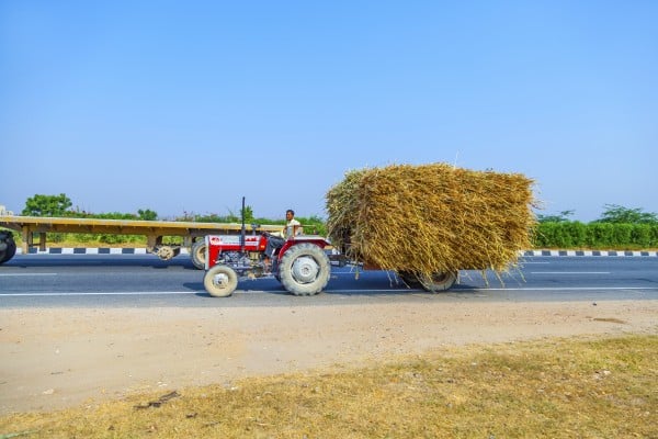 farmer harvest tractor grain straw full