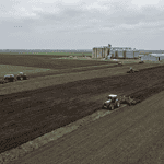 Aerial view of wheat and corn fields in Kazakhstan with agricultural machinery