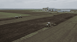 Aerial view of wheat and corn fields in Kazakhstan with agricultural machinery