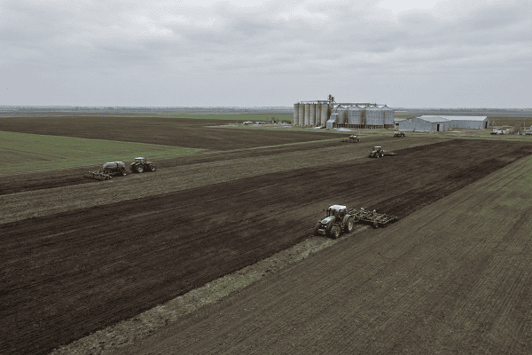 Aerial view of wheat and corn fields in Kazakhstan with agricultural machinery