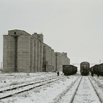 Kazakhstan grain export warehouses and freight wagons.