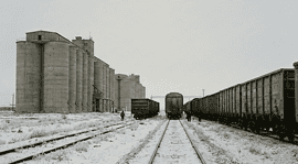 Kazakhstan grain export warehouses and freight wagons.
